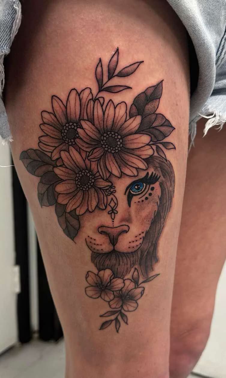 Floral lion thigh tattoo by Sophia