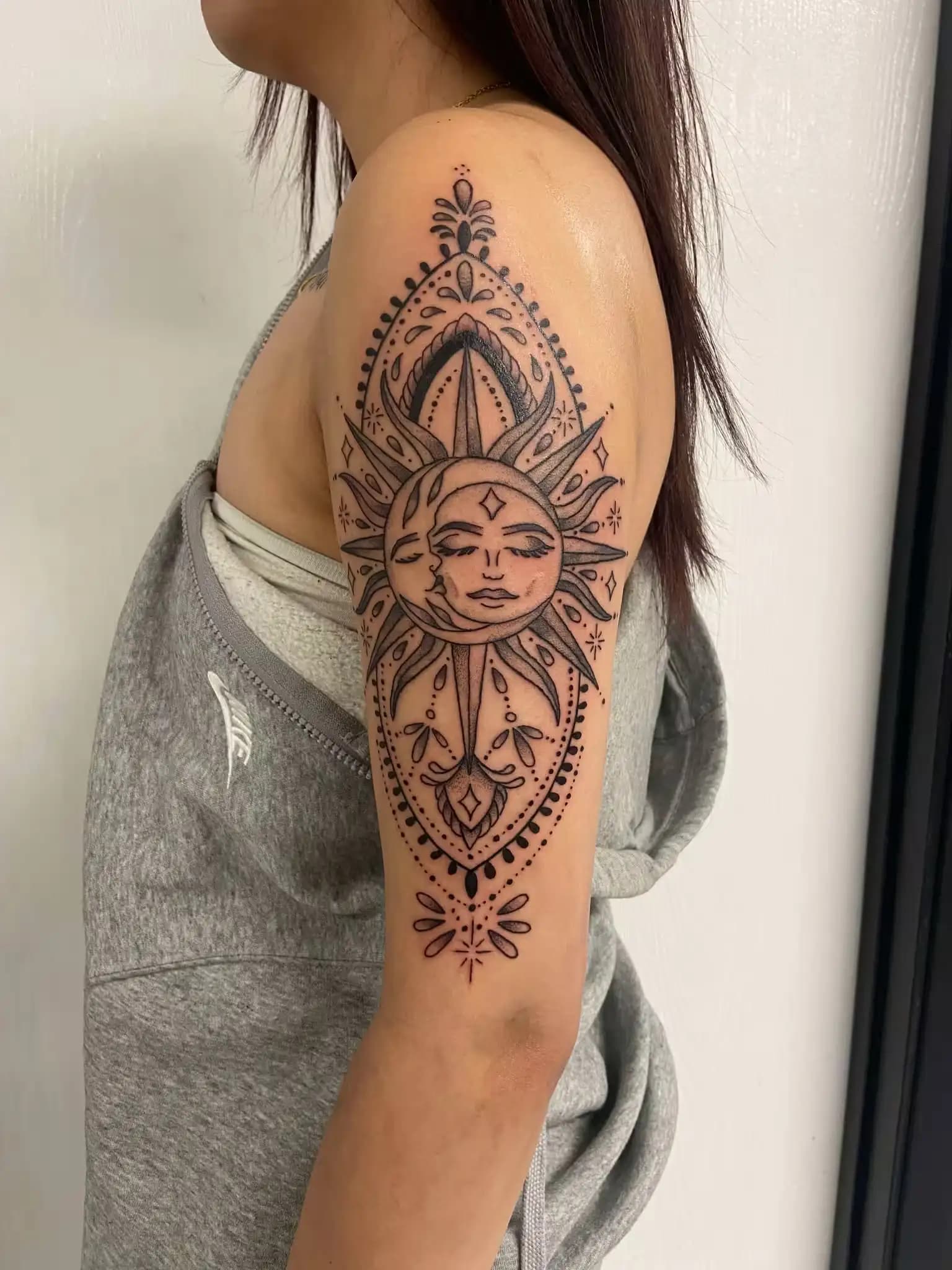 Blackwork sun and moon tattoo by Sophia